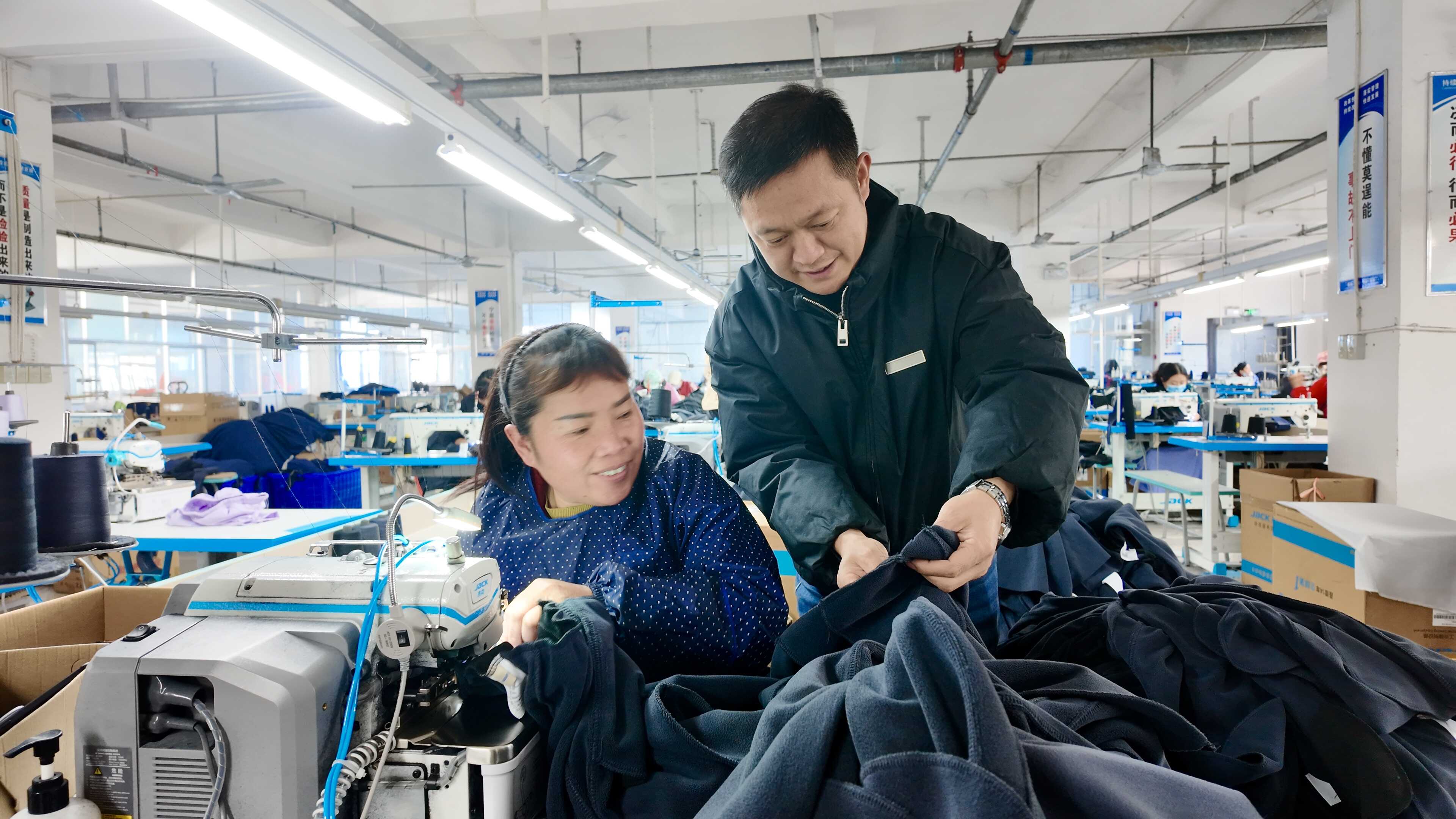 张申强在指导员工缝制技巧。(湖北日报全媒记者 赵怡然 摄).jpg